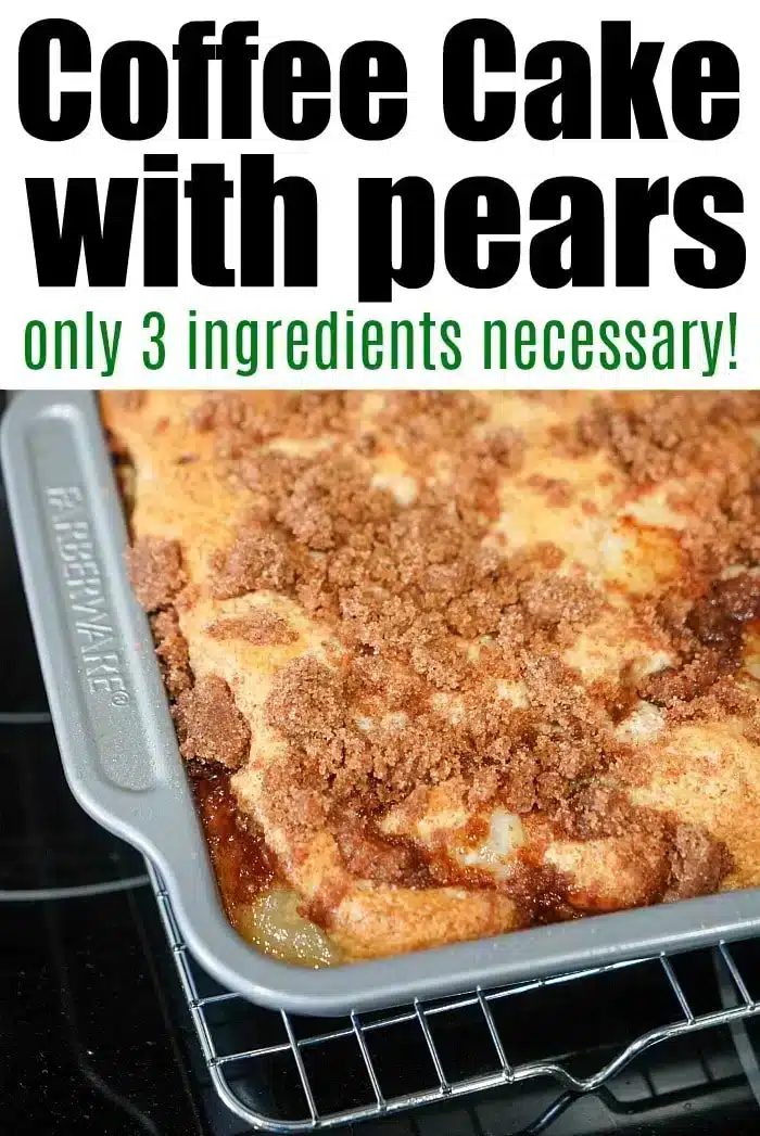 A rectangular coffee cake with pears topped with a crumbly brown streusel sits in a metal baking pan.