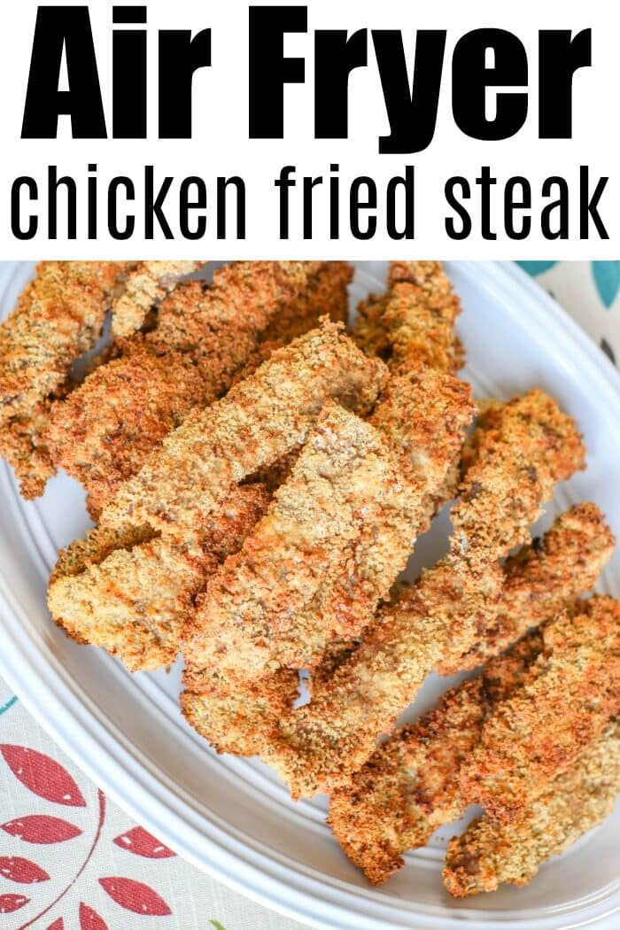 Crispy air fryer chicken fried steak strips are arranged on a white oval plate, showcasing the solid golden-brown crunch.