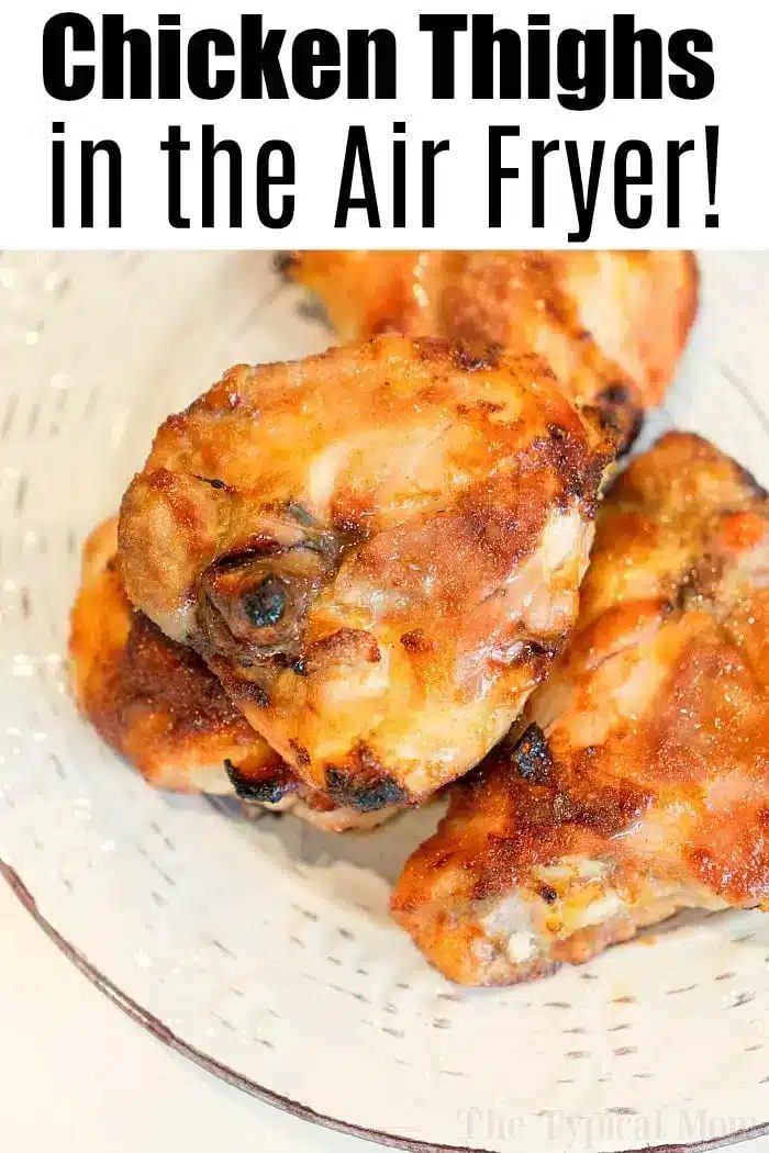 A plate of four bone-in chicken thighs with a crispy, browned coating. The text above reads, "Chicken Thighs in the Air Fryer!" A deliciously easy meal made solid in your air fryer.