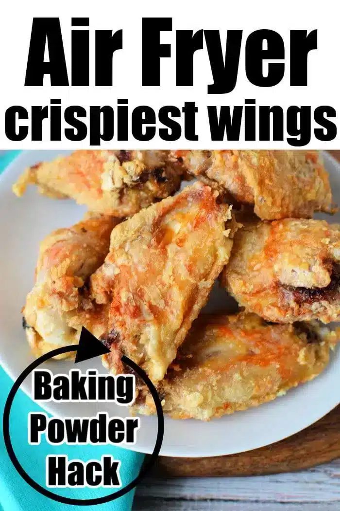 A white plate filled with crispy Air Fryer Chicken Wings sits on a wooden surface with a turquoise napkin beside it. The text on the image reads "Air Fryer crispiest wings" at the top and "Baking Powder Hack" in a black circle on the left side.