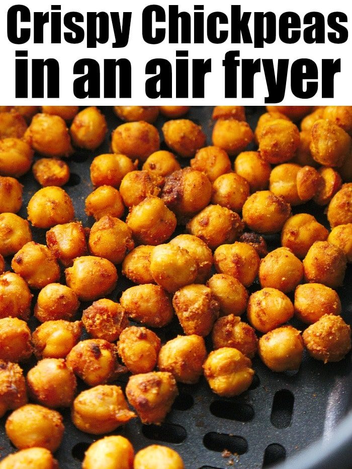 Close-up image of air fryer chickpeas in a basket. The golden brown chickpeas look perfectly seasoned. Text at the top reads "Crispy Chickpeas in an Air Fryer.