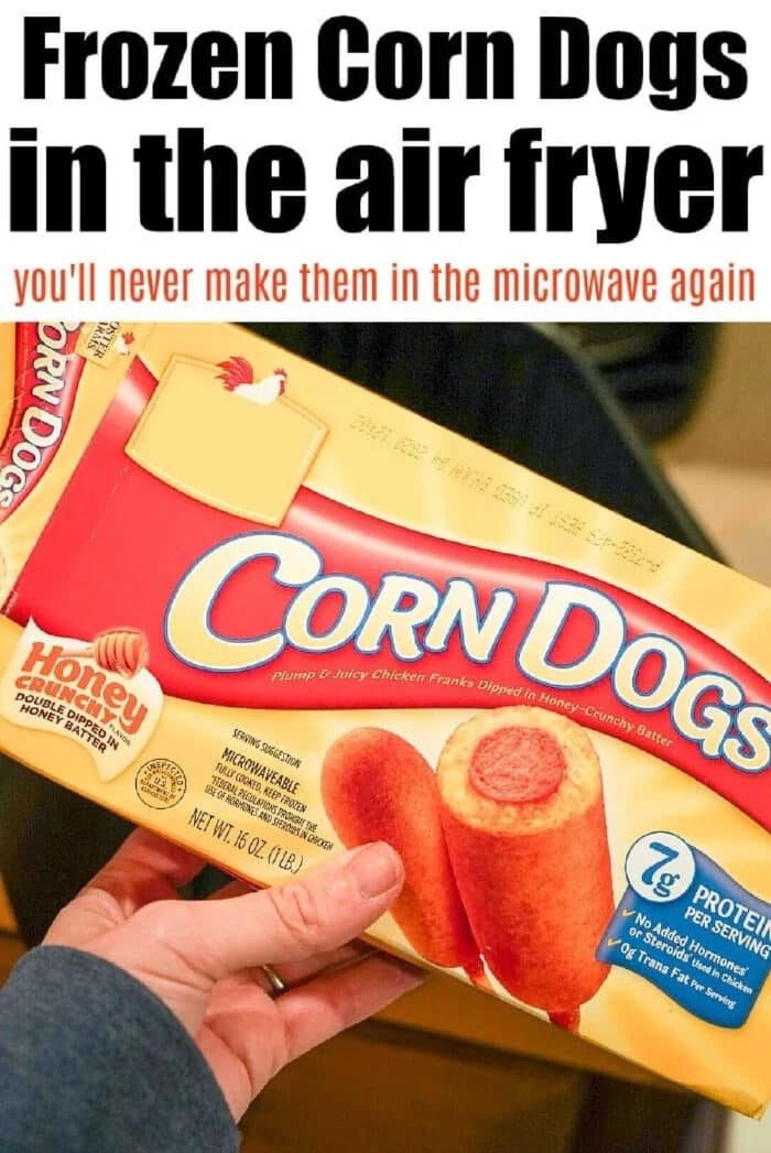 Hand holding a box of corn dogs with text about enjoying crispy frozen air fryer corn dogs instead of microwaving them.