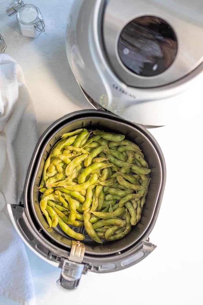An air fryer is the solid tool for effortlessly cooking edamame beans to perfection. The basket is filled with tender, green delights, offering a healthy and good treat thats quick and easy to prepare.