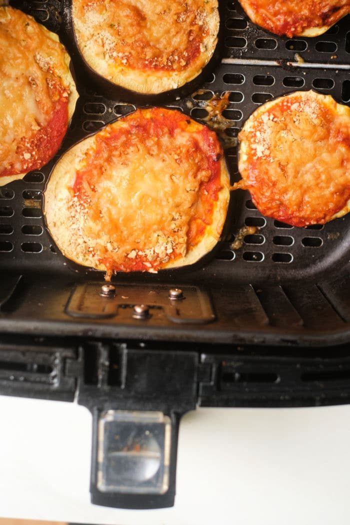 with cheese and tomato sauce cook to perfection in an air fryer basket, bringing a crisp texture similar to that of an air fryer eggplant parm.