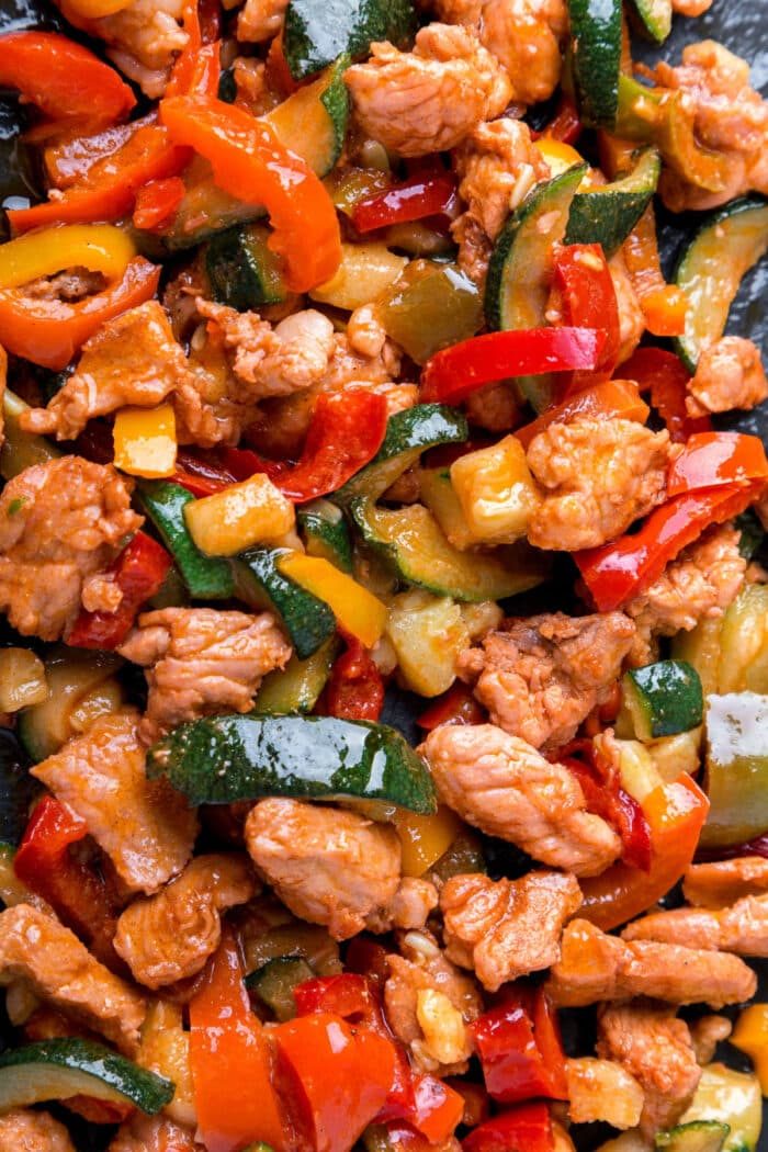Delight in this air fryer fajitas featuring juicy chicken strips, vibrant red and yellow bell peppers, and crisp zucchini slices for a quick fajitas twist.