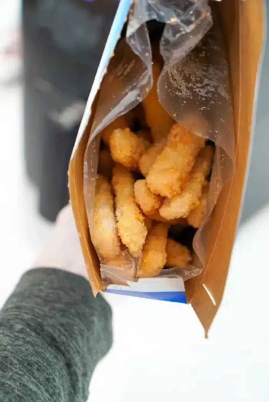 Open box of frozen breaded fish sticks viewed from above, solid for making crispy air fryer fish sticks at home.