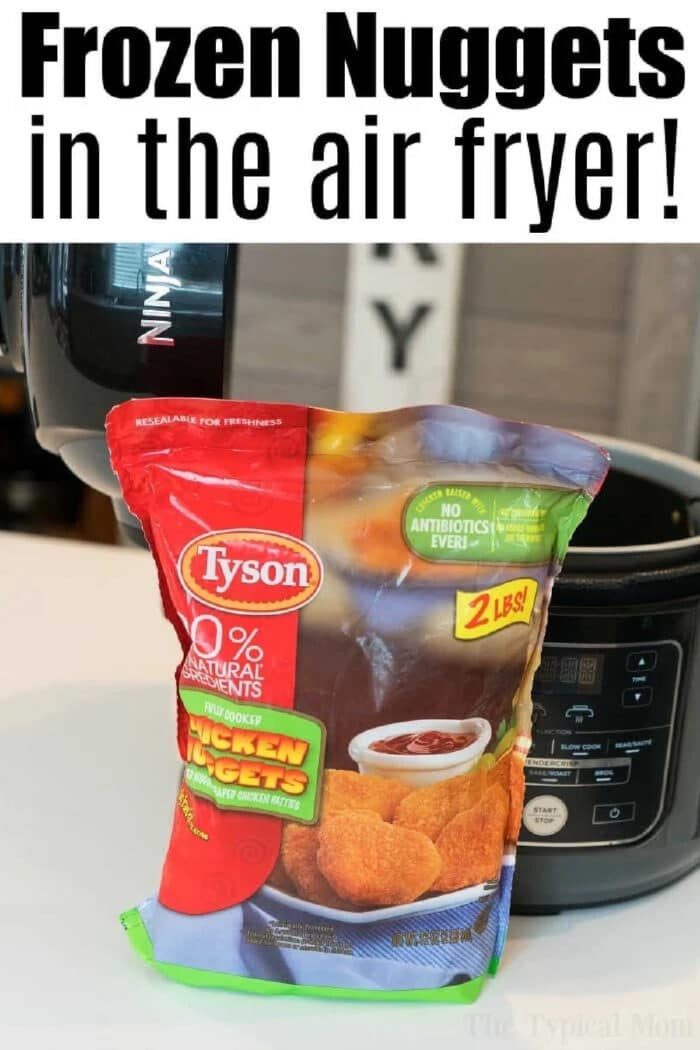 A bag of Tyson air fryer frozen chicken nuggets sits on a kitchen counter in front of an open air fryer, ready for a quick and easy meal.