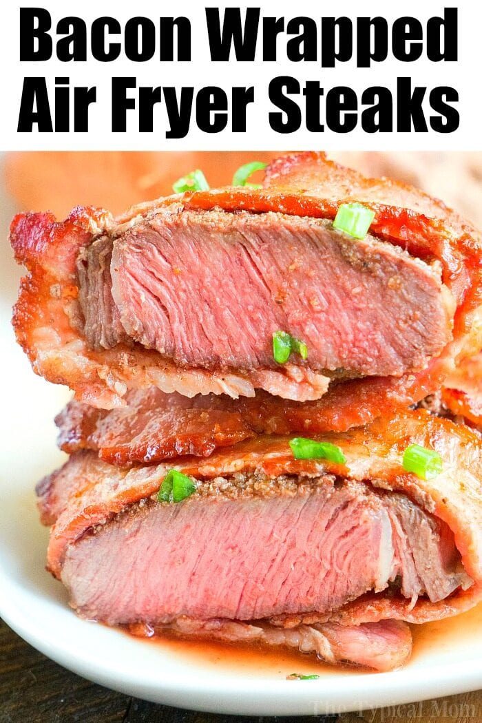Sliced bacon-wrapped air fryer steaks cooked to perfection, topped with fresh green onions and beautifully presented on a plate.
