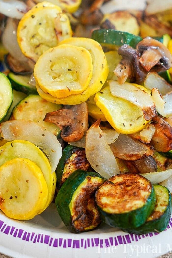 A plate of good air fried vegetables, including yellow squash, zucchini, onions, and mushrooms, showcases the ease and flavor of air fryer vegetable recipes.
