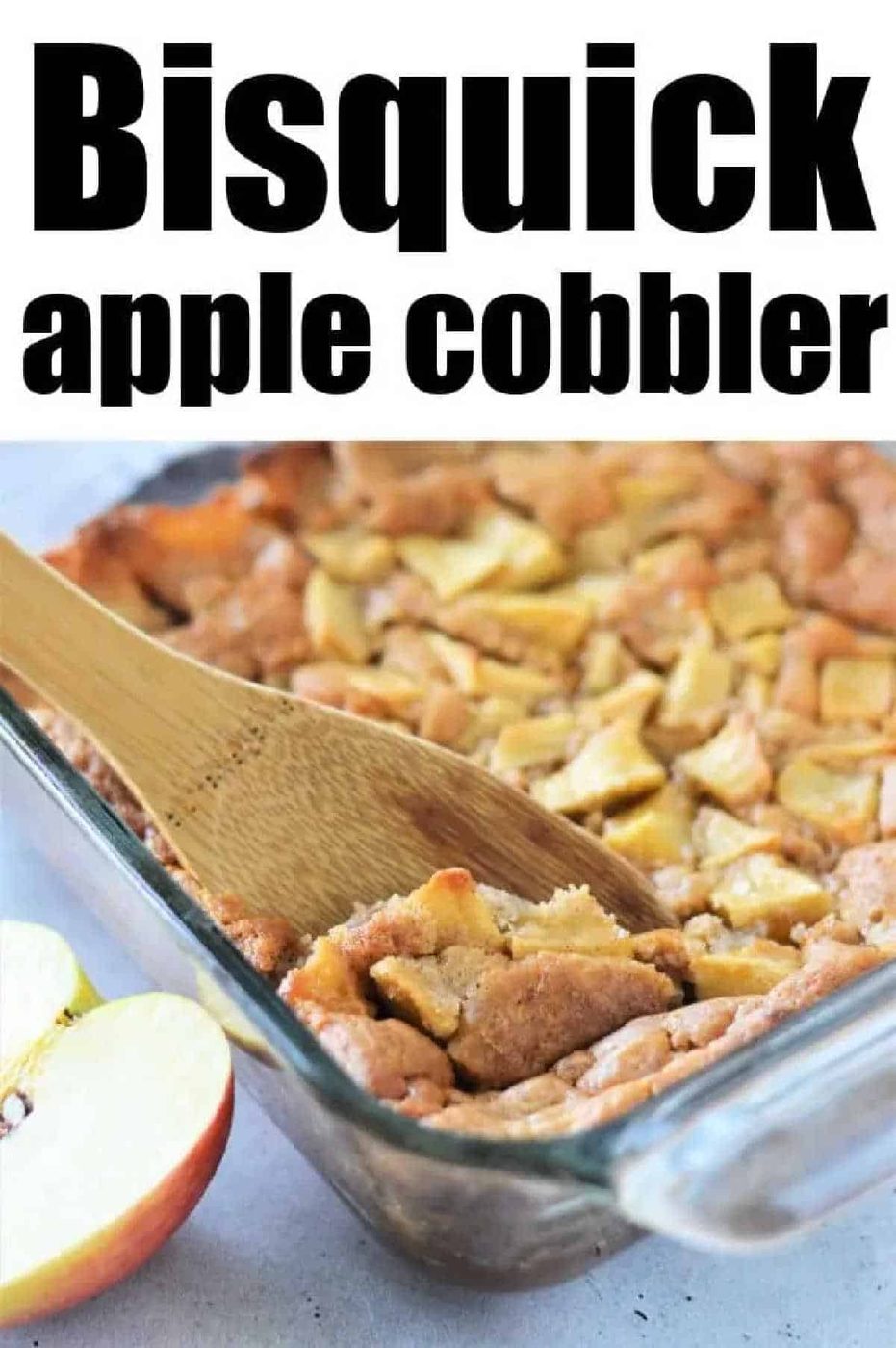 A wooden spoon scoops Apple Cobbler with Bisquick from a glass baking dish; apple slices are visible.