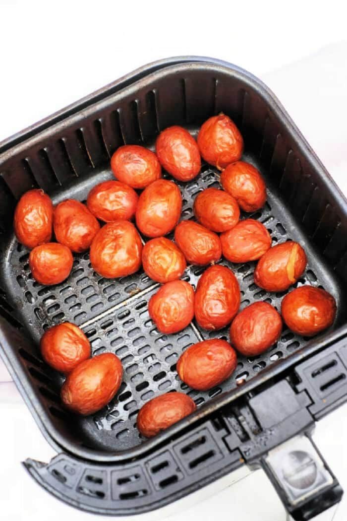 Freshly cooked baby red potatoes, nestled in a black air fryer basket, offer a delightful twist on your favorite baby potatoes recipe.