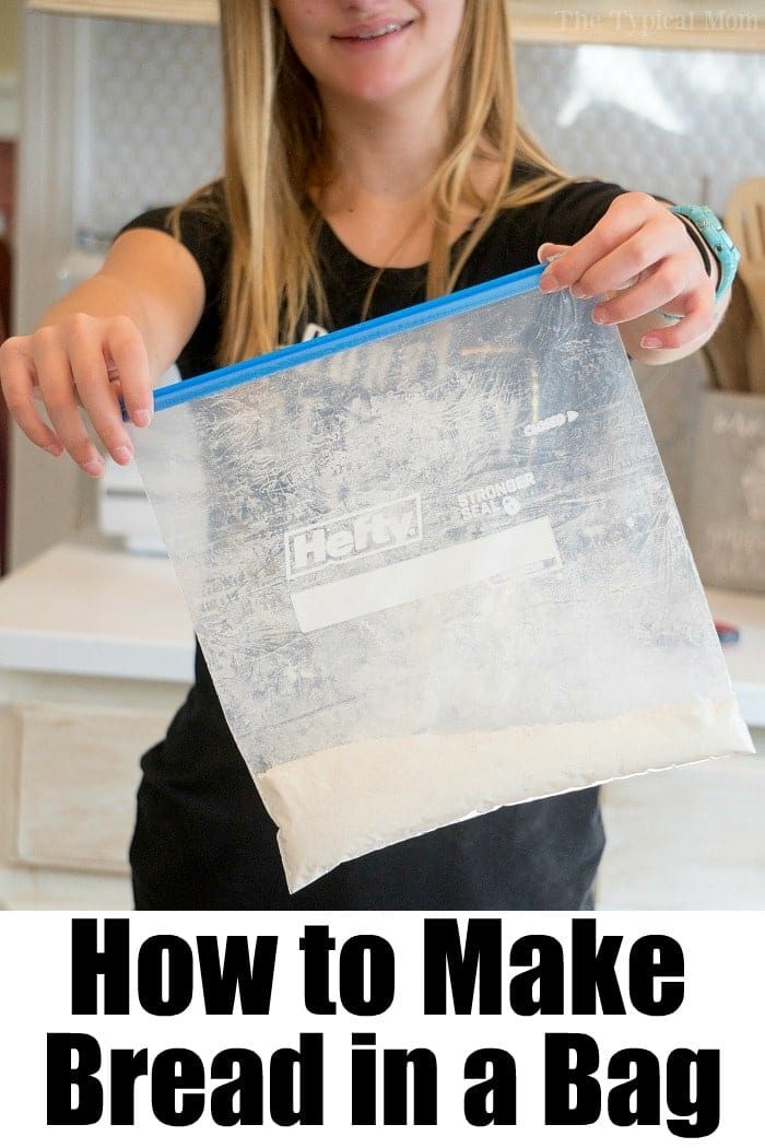 Person holding a clear zip-lock bag containing whole wheat flour, with text at the bottom reading How to Make Bread in a Bag.