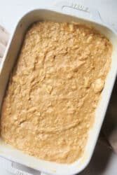 Banana coffee cake batter in a white baking dish, ready to be baked.