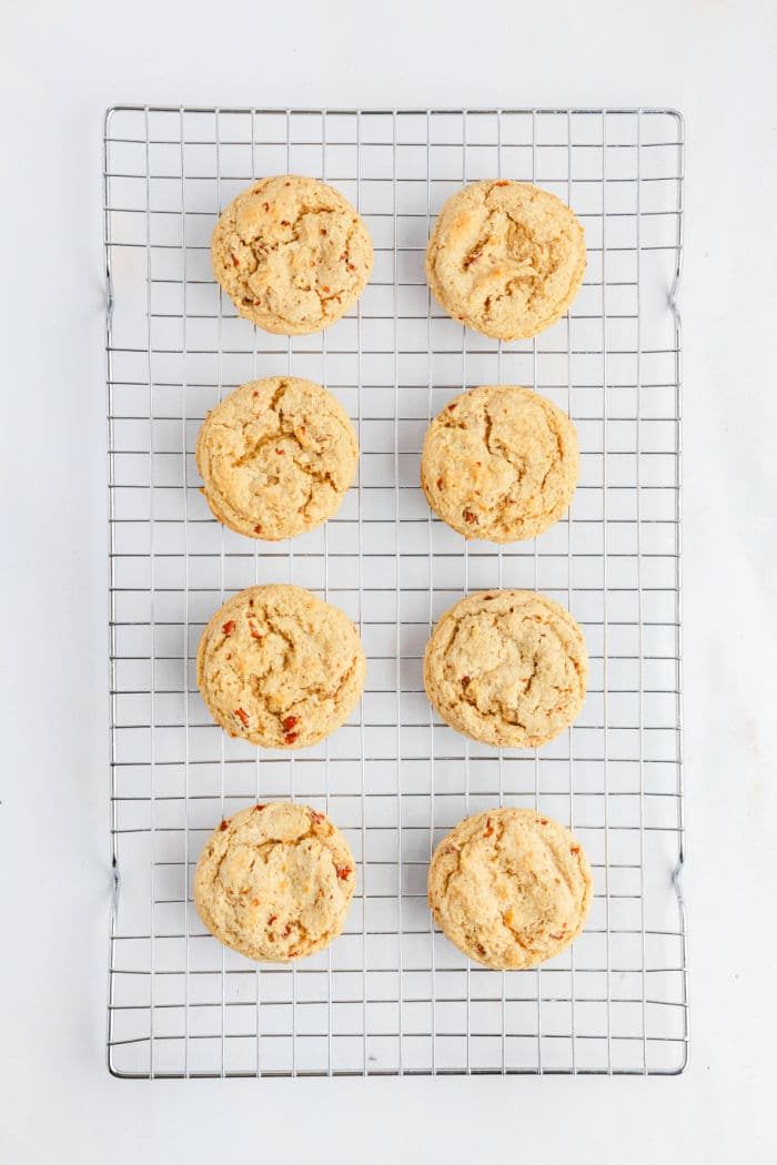 Eight butter pecan Cookies cooling on a wire rack, arranged in two neat columns on a white background.