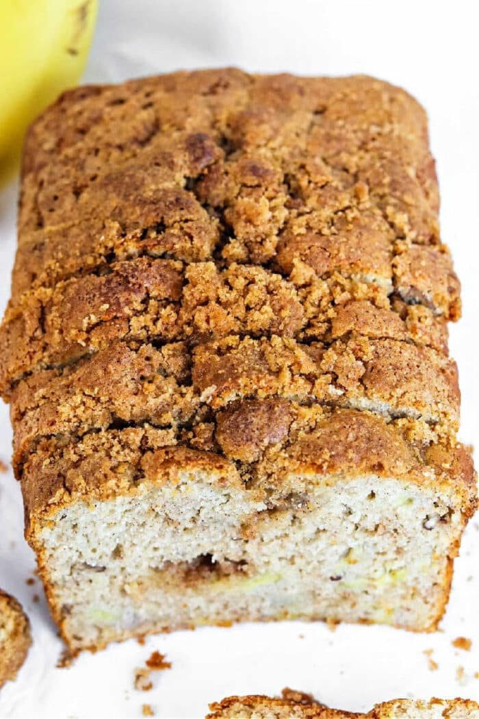 A sliced loaf of banana bread with a crumbly, golden-brown streusel topping, made using a classic Bisquick banana bread recipe.
