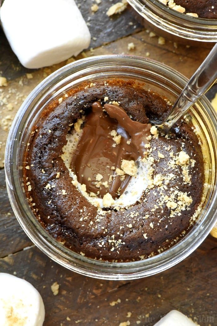 Chocolate cake in a jar with a melted center, topped with crumbs, and a spoon digging in—this dessert is the solid example of how boxed cake mix recipes can be elevated to something irresistibly decadent. Fluffy marshmallows nearby add a playful touch.