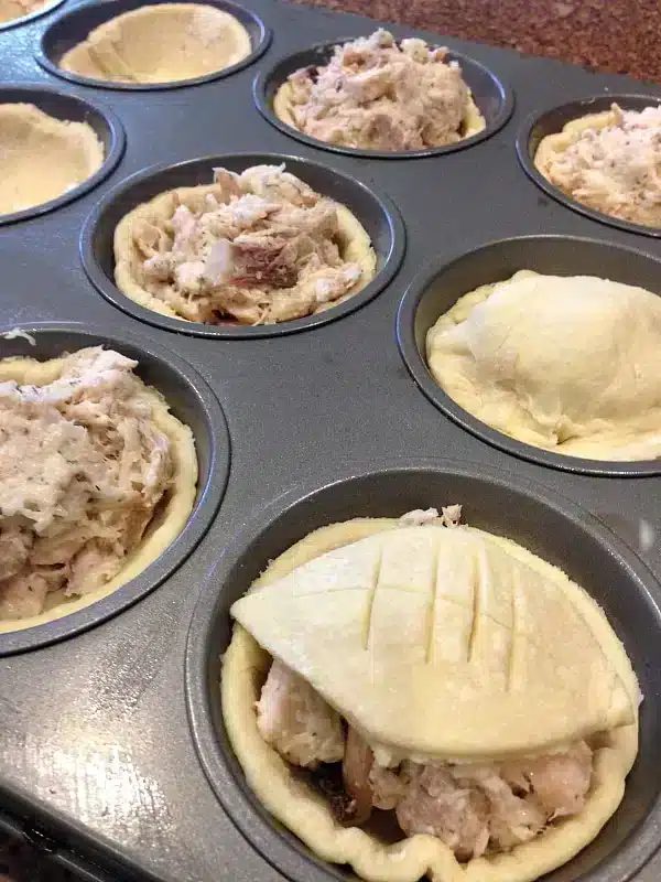 chicken pot pie with puff pastry in muffin tin