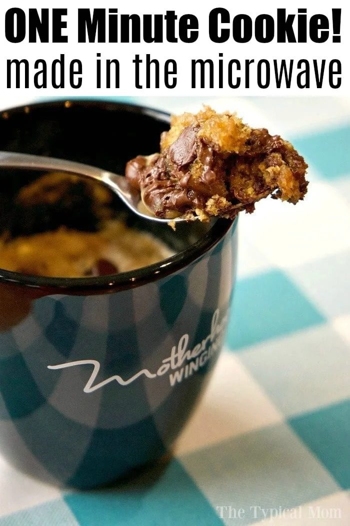 Cup with a spoonful of chocolate chip cookie in a mug, text reads ONE Minute Cookie! made in the microwave.