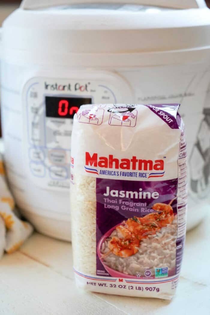 A bag of Mahatma Jasmine rice sits on a kitchen counter in front of an Instant Pot, solid for cooking jasmine rice in an Instant Pot effortlessly.