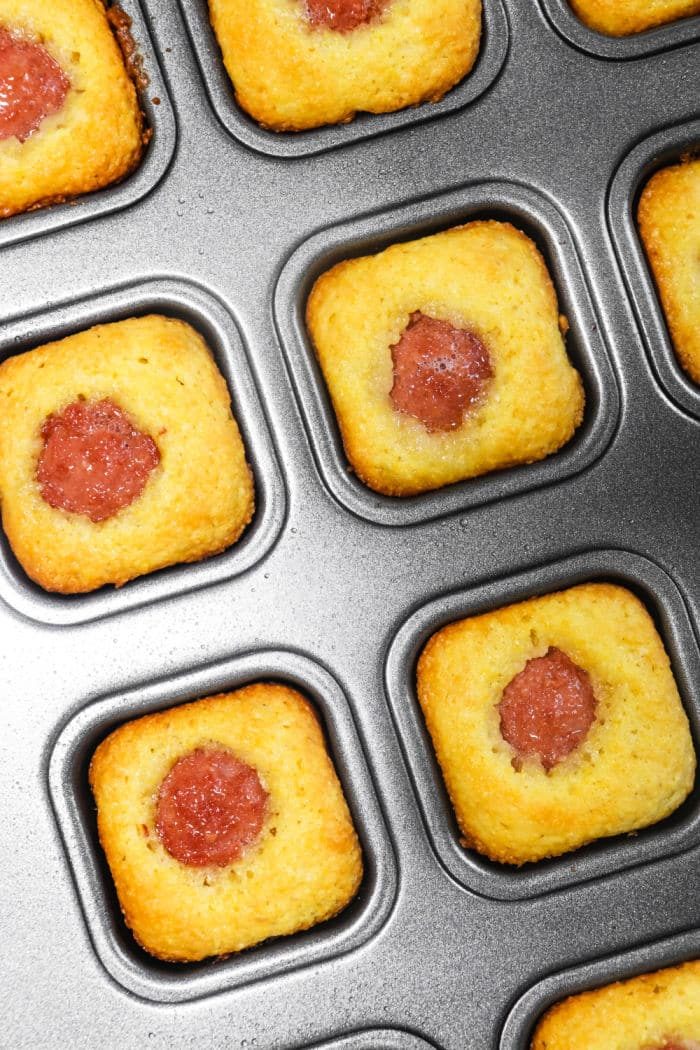 Corn dog bites served in a square muffin tin.