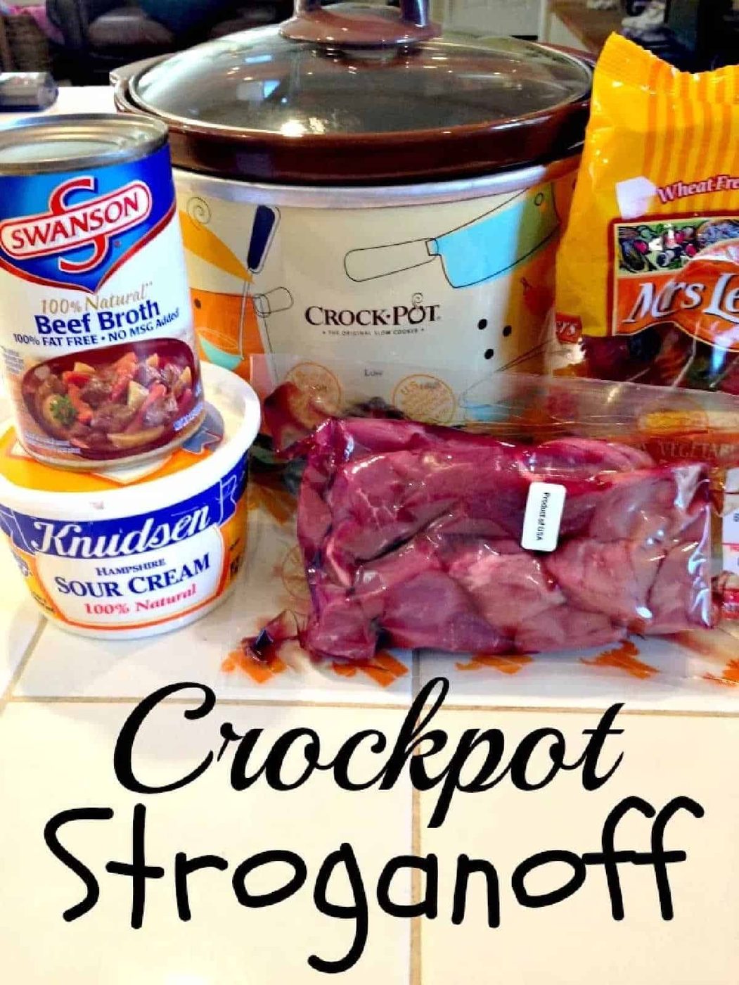 Crockpot beef stroganoff ingredients—beef broth, sour cream, noodles, and tender beef—arranged on a counter and ready for your next cozy meal.