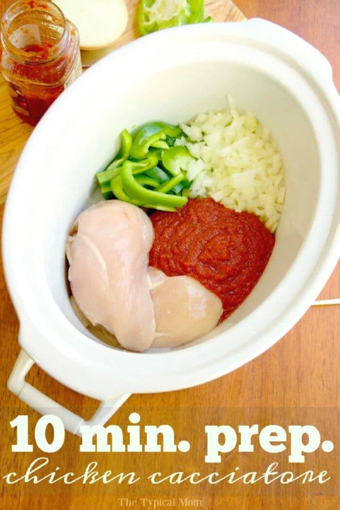 Uncooked chicken, tomato sauce, chopped onions, and green peppers in a slow cooker—everything you need to prep classic crockpot chicken cacciatore.