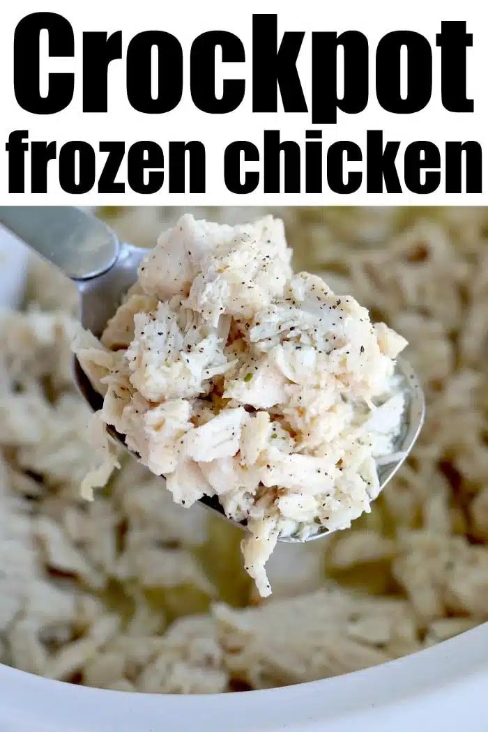 A spoonful of shredded crockpot frozen chicken over a crockpot with the text Crockpot Frozen Chicken above.