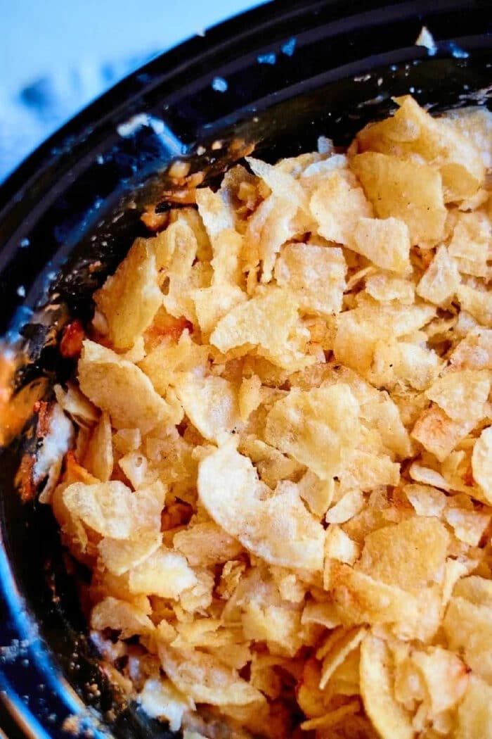 Close-up of crispy browned potato chips crust on crockpot funeral potatoes.