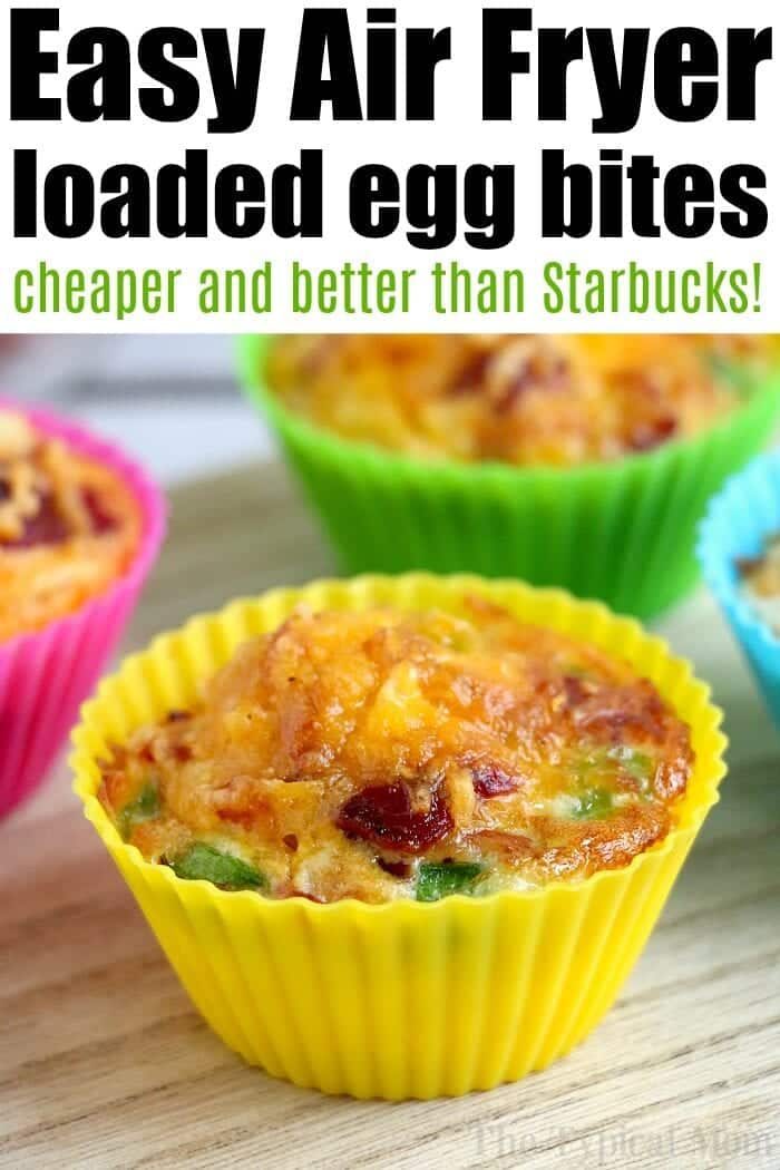 Colorful silicone cups holding air fryer egg bites with vegetables rest on a wooden surface.