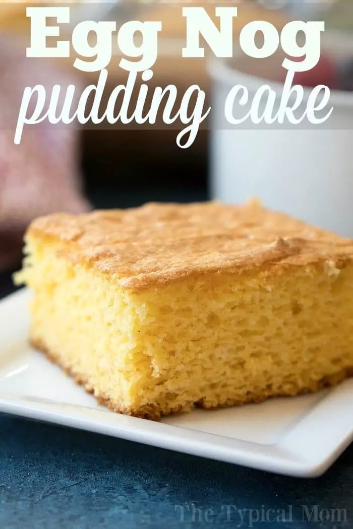 A close-up photo of a slice of eggnog pudding cake on a white square plate.