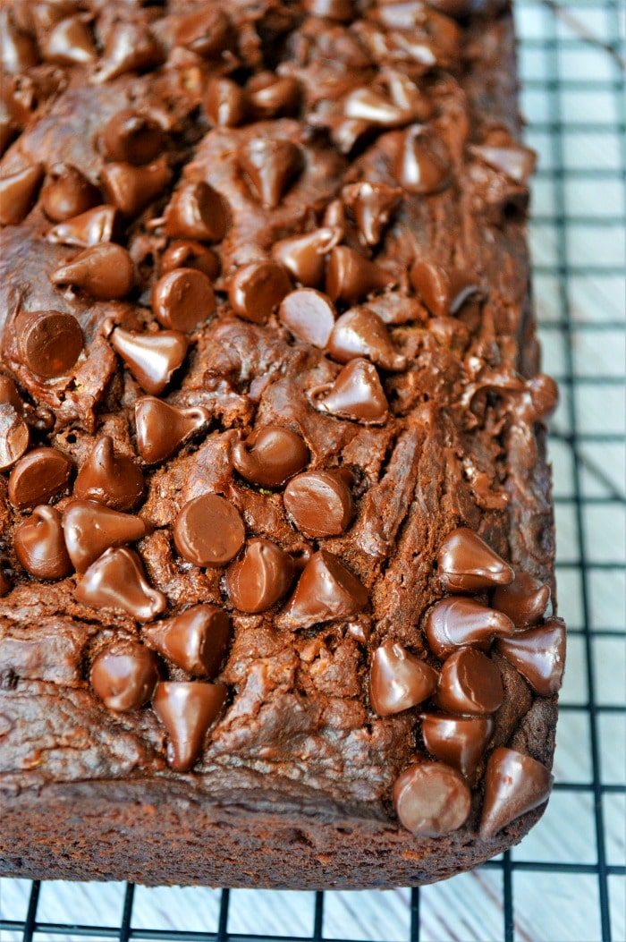A close-up of chocolate chip pumpkin bread on a cooling rack, resembling a delectable slice of chocolate pumpkin cake.