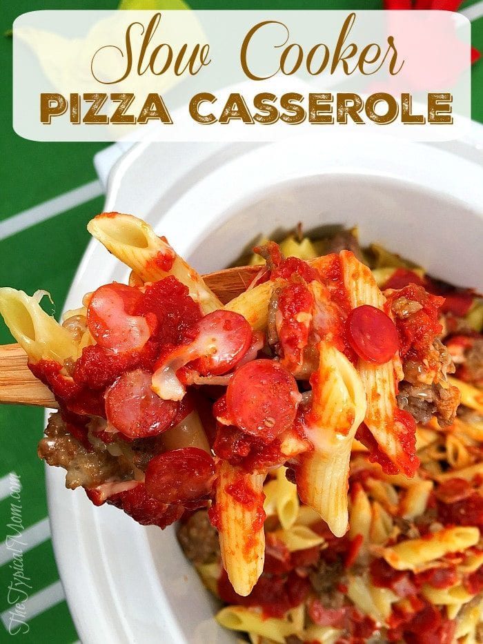 Close-up of a wooden spoon lifting a portion of easy slow cooker pizza casserole with penne pasta, pepperoni, and tomato sauce. Text on image reads, Slow Cooker Pizza Casserole - an effortless addition to your collection of easy slow cooker recipes.