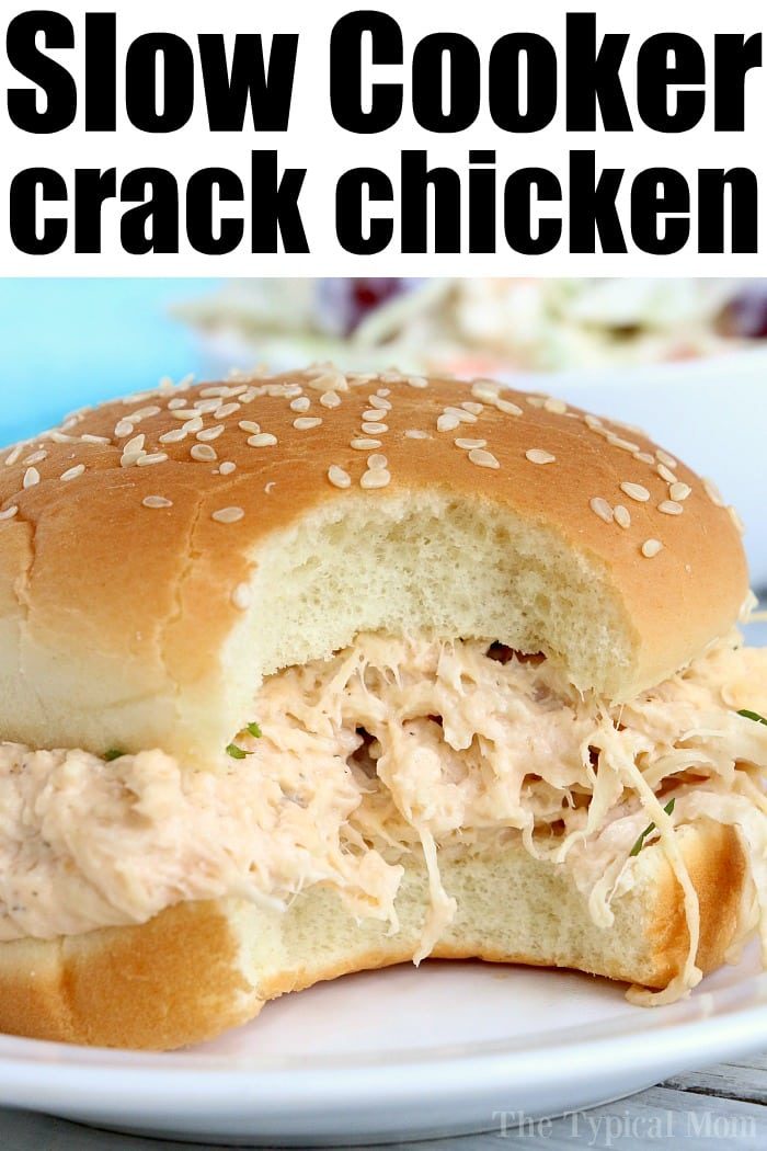 A close-up of a sesame seed bun sandwich overflowing with creamy, shredded chicken captures the eye. The text Crockpot Crack Chicken is displayed at the top of the image, enticingly highlighting its slow-cooked deliciousness.