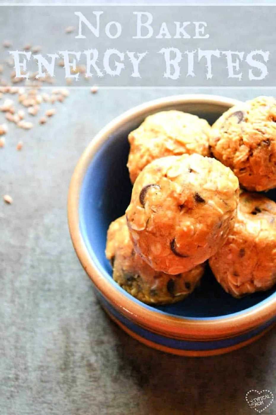 A blue bowl filled with no-bake energy bites sits on a gray surface, with text above reading No Bake Energy Bites—a simple and good energy ball recipe solid for quick snacks.
