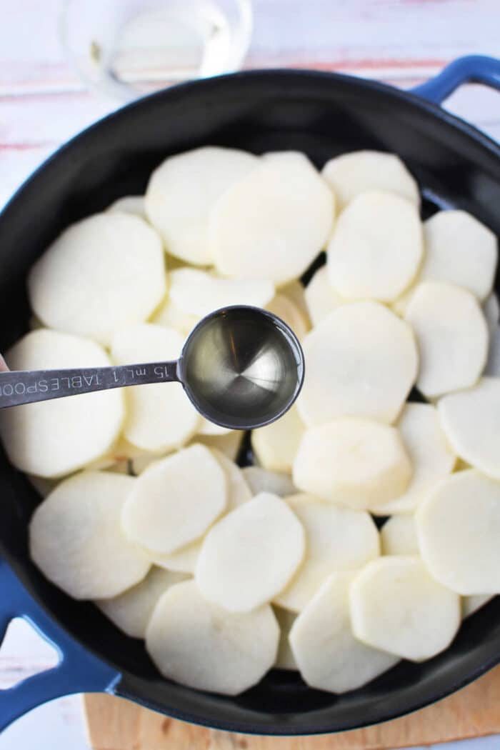 Pan-fried potatoes with onions and peppers, showcasing crispy edges and colorful, tender vegetables.