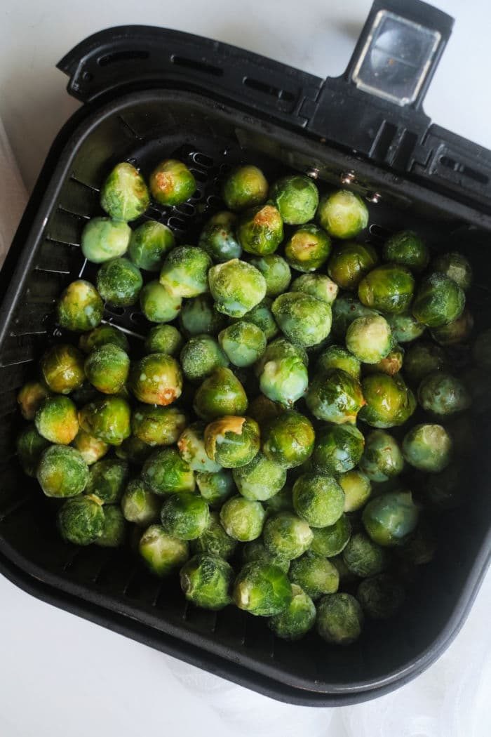 Frozen brussel sprouts air fryer-ready in a basket, solid for quick and easy cooking.