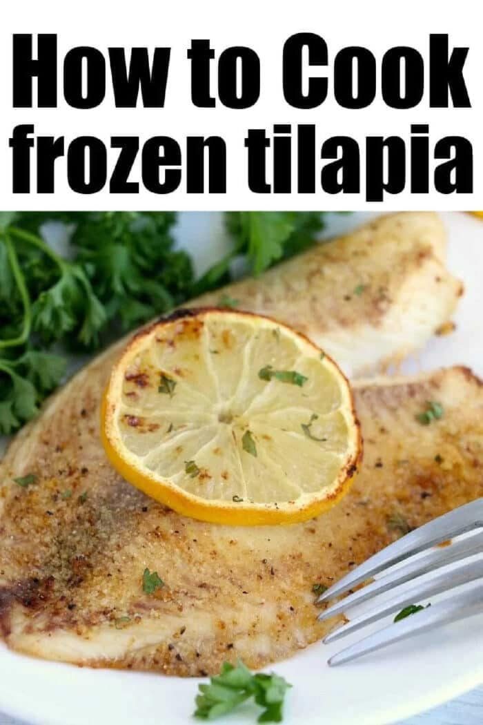 Cooked tilapia, fresh from the air fryer, with a lemon slice and parsley garnish sits enticingly on a white plate, alongside a gleaming fork.