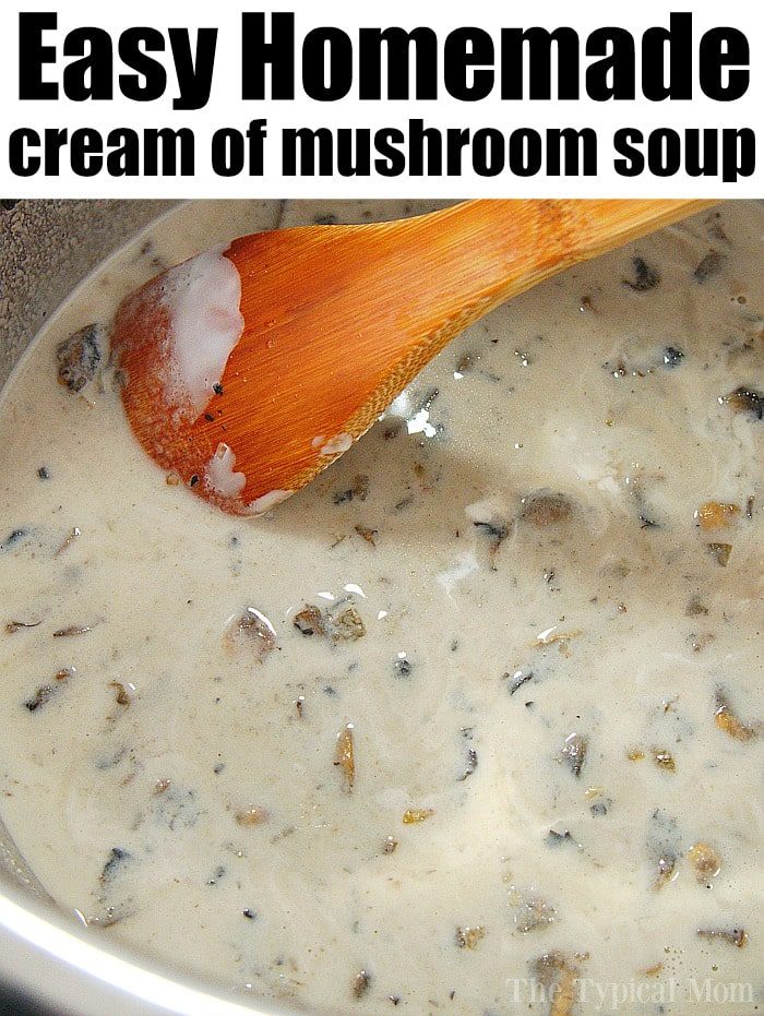 A close-up reveals the rich texture of homemade cream of mushroom soup being gently stirred with a wooden spoon in a pot.