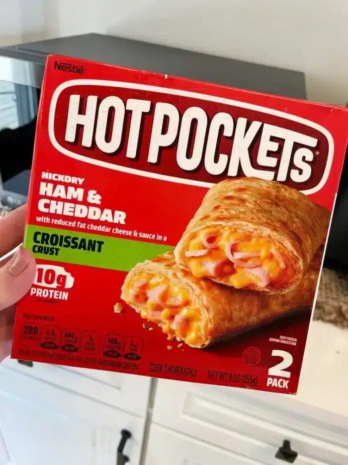 A person holding a box of Nestlé Hot Pockets wonders