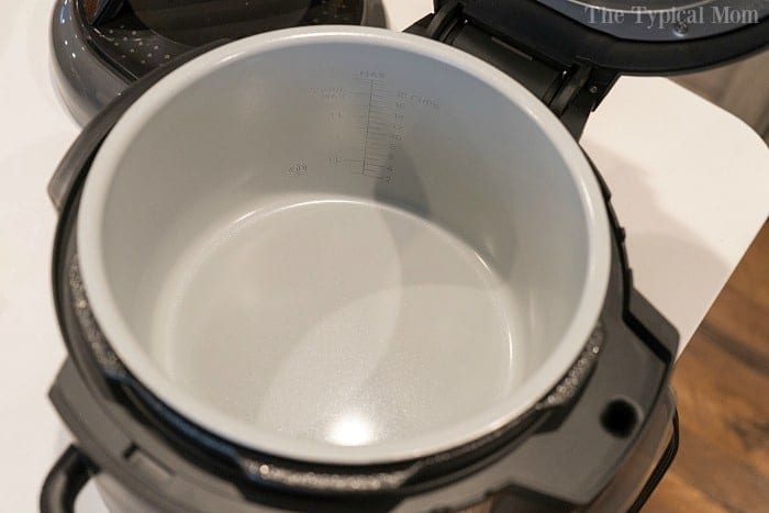Open modern pressure cooker with a non-stick interior sits on the kitchen counter, ready for your next culinary adventure. Keep it pristine and performing at its best by learning how to clean your instant pot efficiently.