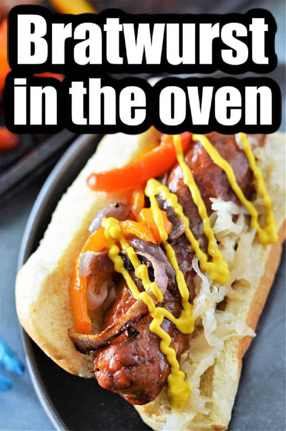 Bratwurst sausage in a bun with sauerkraut, peppers, onions, and mustard—solid for learning how to cook bratwurst in the oven.