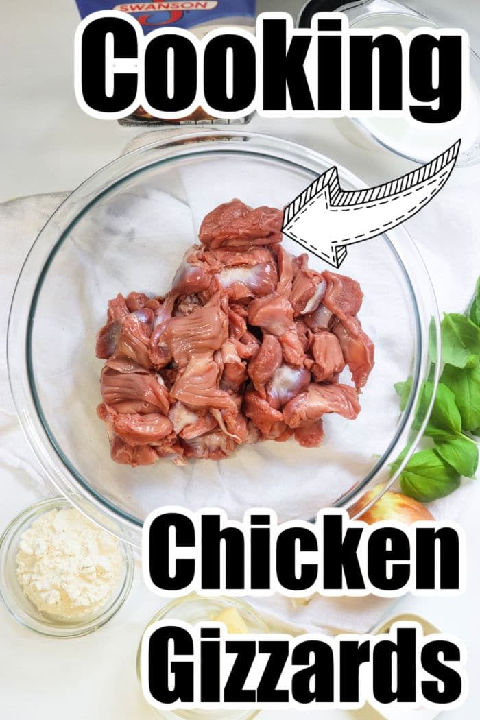 Raw chicken gizzards in a glass bowl with How to Cook Chicken Gizzards text displayed over the image.