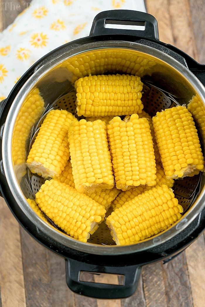 Corn on the cob pieces are artfully arranged in a steaming basket inside an Instant Pot, transforming it into the solid pressure cooker for effortless, good results.