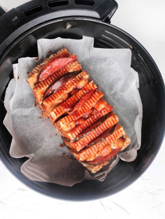 A loaf of halloumi cheese sliced and cooked in the air fryer