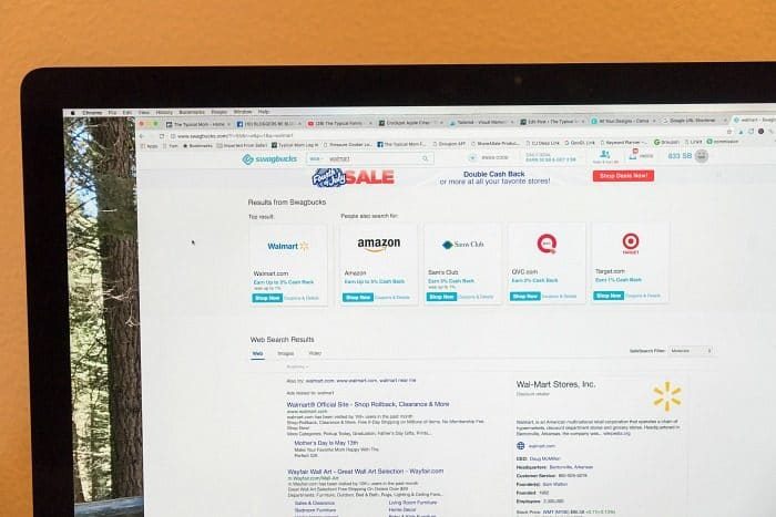 A computer screen displays search results for various online retailers and a website listing, including guides on how to make money on Swagbucks efficiently.