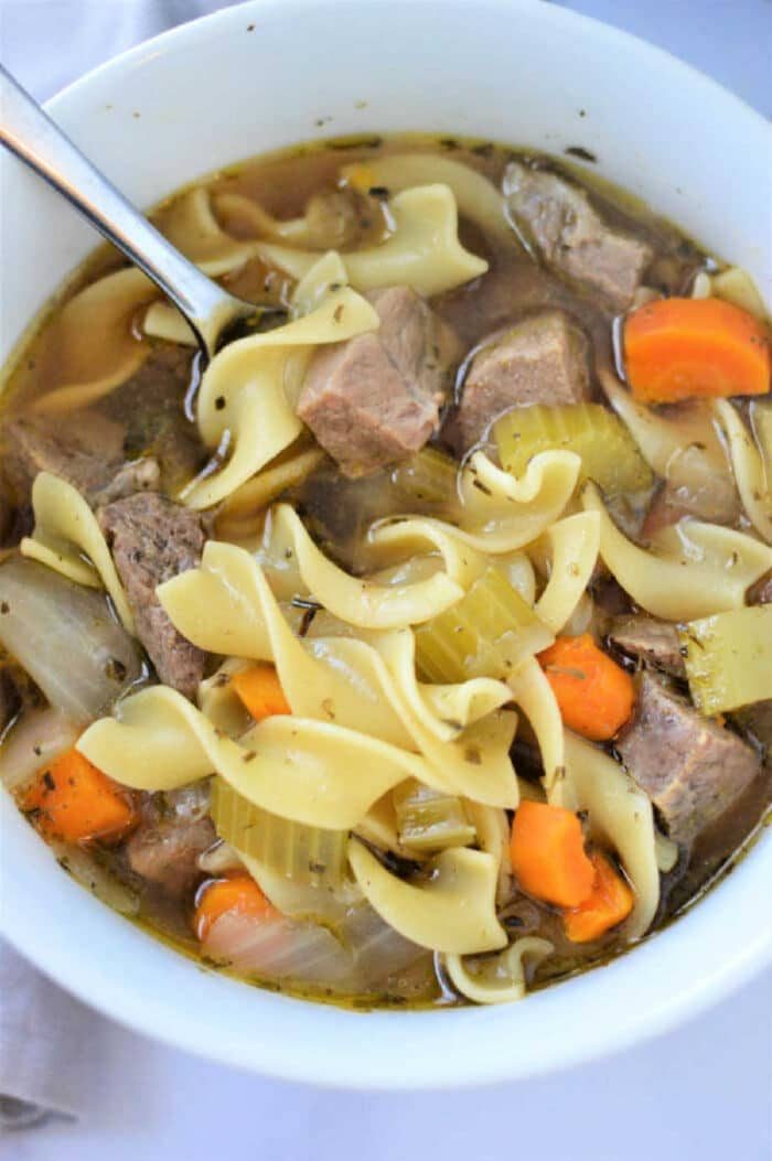 A bowl of hearty instant pot beef noodle soup with tender meat and savory broth.