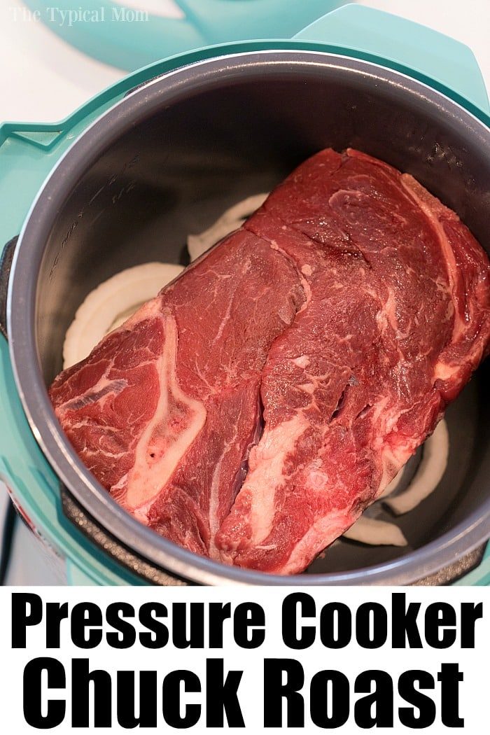 Raw chuck roast nestled alongside onion slices in an Instant Pot, creating a savory beef roast recipe that promises tender perfection.