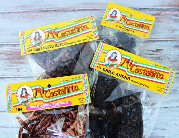 Four packets of dried chiles labeled Chile Nuevo Mexico, Cascabel, Chile Ancho, and Chile Árbol Tostado—solid for adding authentic flavor to Instant Pot Birria Tacos.