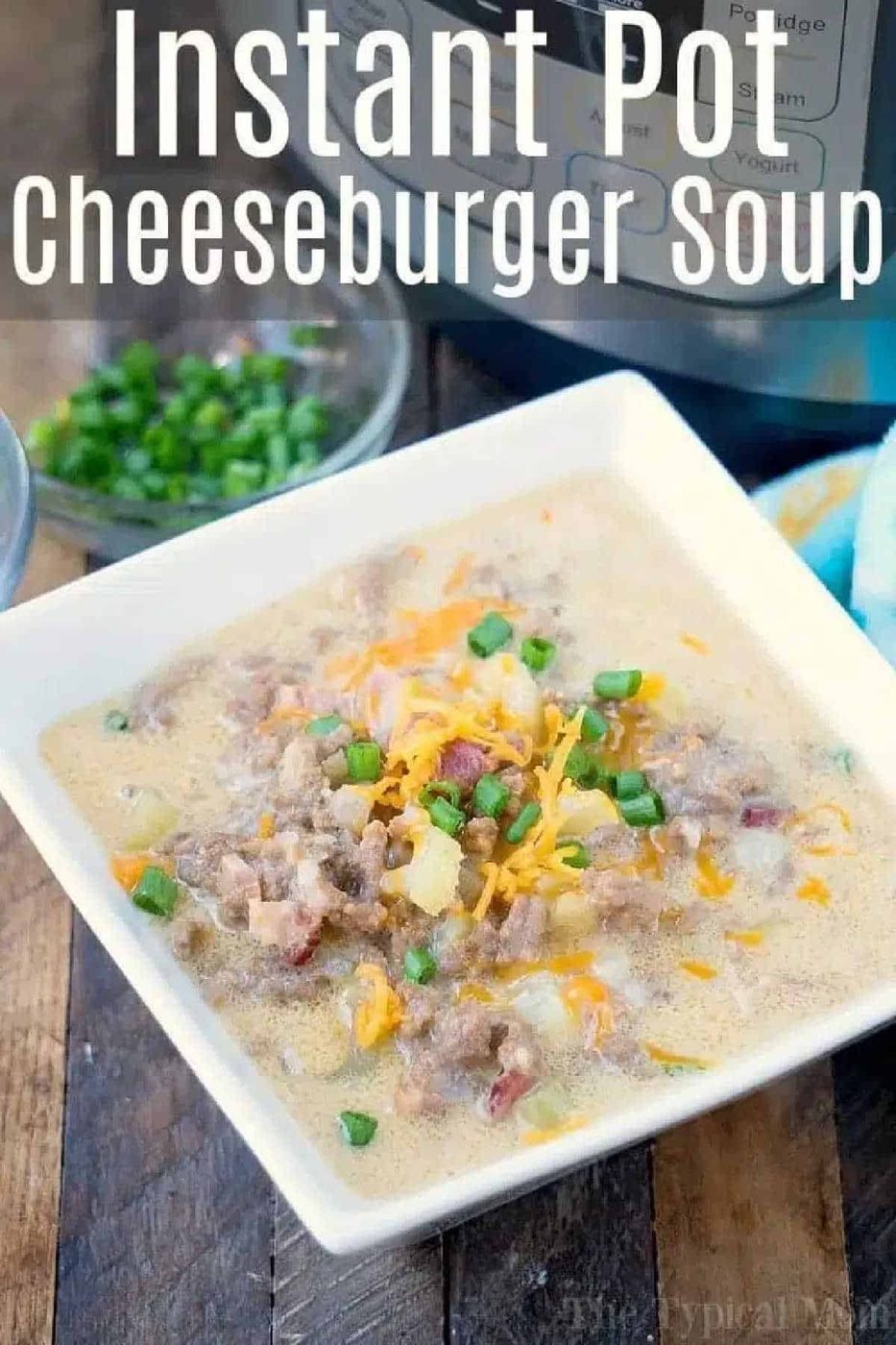 Square bowl of instant pot cheeseburger soup topped with shredded cheese and green onions, with an Instant Pot in the background.