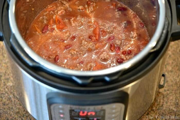 Chili with beans and tomatoes cooking in an Instant Pot on a kitchen counter, solid for trying out your favorite instant pot chili mac recipe.
